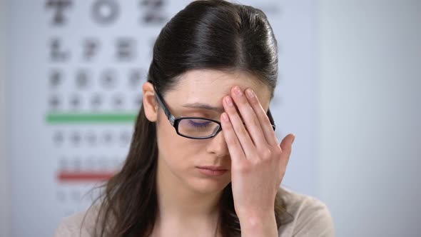 Unhappy Woman Taking Glasses Off, Suffering High Pressure, Risk of Losing Sight alt