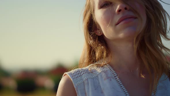 Relaxed Woman Looking at Camera with Passion Outside alt