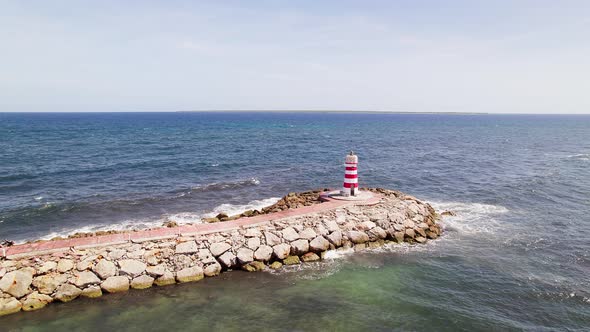Drone pull out aerial shot of a lighthouse in Ireland