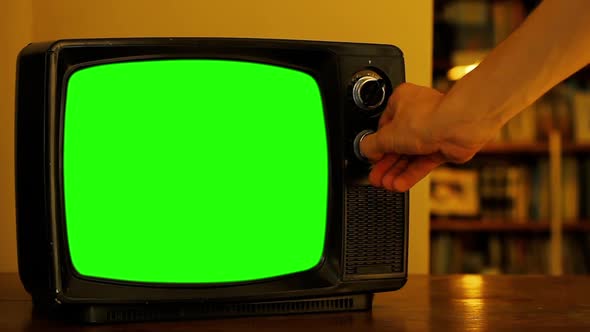 Man Turning Channel Knob on Retro Television Green Screen. alt