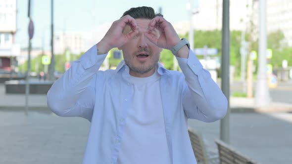 Happy Man Searching with Handmade Binocular Outdoor alt