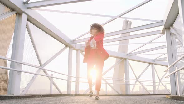 Young mixed race carefree girl enjoys the day and dancing in slow motion.