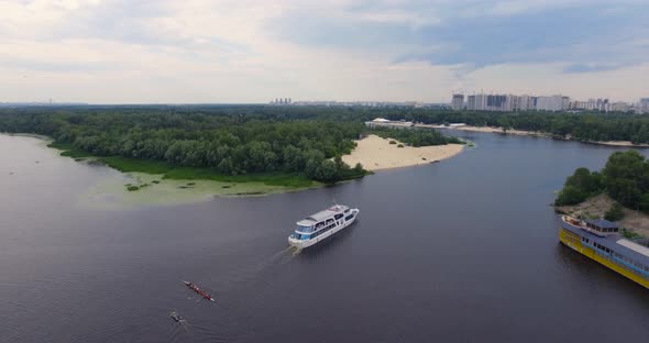 Long Drone Flight over Passenger Ship Sails along City River
