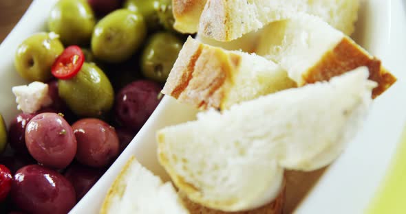 Olive tapas and pieces of bread alt
