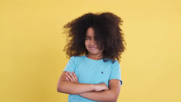 Cunning Clever Darkskinned Female Child Shaking Head and Shows Disagree alt