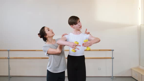 Ballet Gymnastics Class Teacher Choreographer Helps Student to Improve Exercise