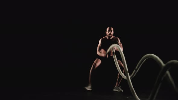 Athletic Man Training with Battle Ropes alt
