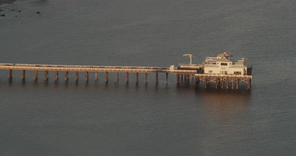 Helicopter shot of cars on California PCH highway angled upside down, day alt