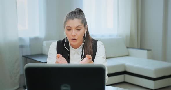 Concentrated Student with Ponytail Talks at Online Lecture alt