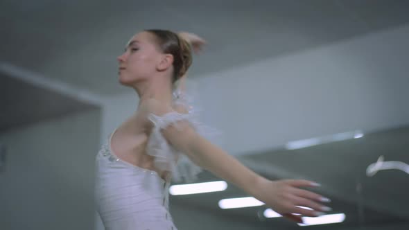 Slim Agile Ballerina in White Dress Spinning As Live Camera Moves Around Ballet Dancer Rehearsing in alt