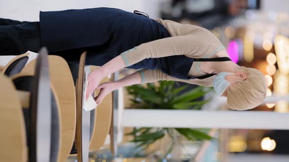 Caucasian Middleaged Woman Waitress Barista Using Towel Sweeping Table in Cafe Cafeteria Sanitizer alt