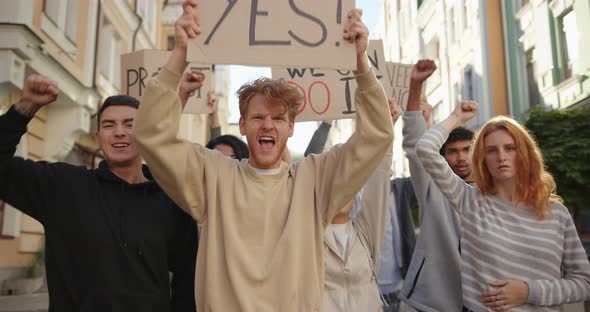 Public Demonstration of Angry Activists Students with Posters at City Streets alt