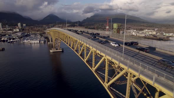 Drone flying along Ironworkers Memorial Bridge on Burrard Inlet in Vancouver, British Columbia, Cana alt