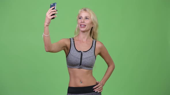 Young Beautiful Woman Vlogging with Phone Ready for Gym