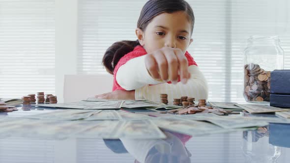 Girl as executive sitting in front of current on the table alt