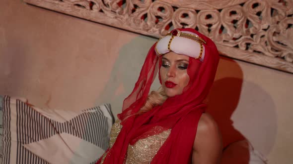 Portrait of a Woman in a Turban a Red Scarf and a Sequined Dress in the Sunset Light alt