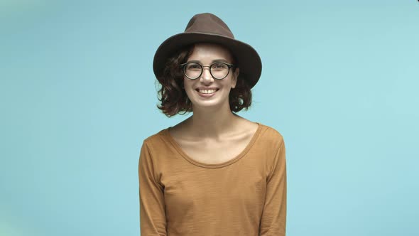 Beautiful Smiling Woman Tourist in Glasses and Trendy Hat Smiling at Camera Looking Happy Standing