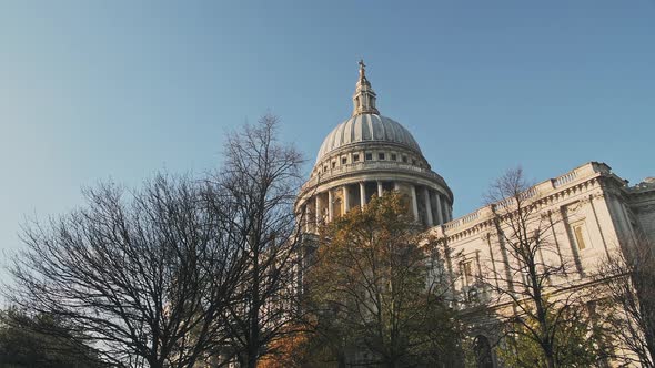 Popular London tourist attraction and landmark of St Pauls Cathedral on a bright blue sky day with A alt