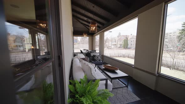 porch and patio with nice furniture, light fixtures, and screened windows on a nice summer day alt