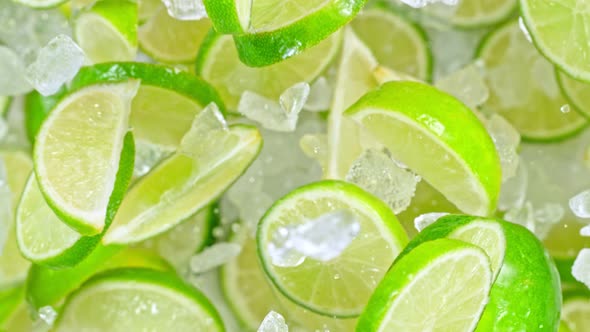 Super Slow Motion Shot of Flying Fresh Lime Slices and Crushed Ice Towards Camera at 1000Fps alt