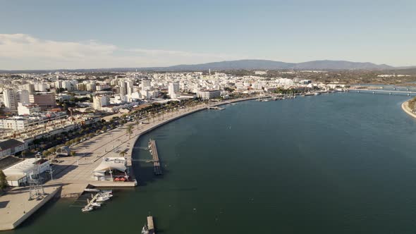 Portimao city and seafront promenade, Portugal. Aerial forward alt