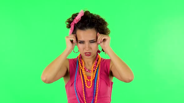 Woman Suffering From Headache From Fatigue Against Green Screen at Studio. alt