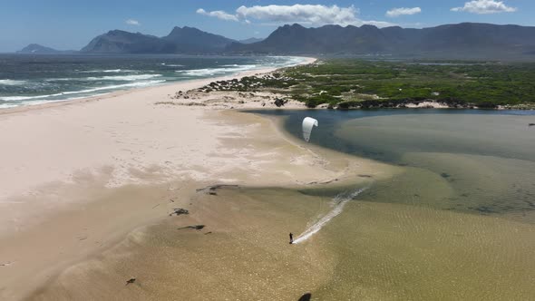 Beautiful Aerial Drone Shot of Kitesurfing Cruising on a Lagoon in Hermanus South Africa During a Pe alt