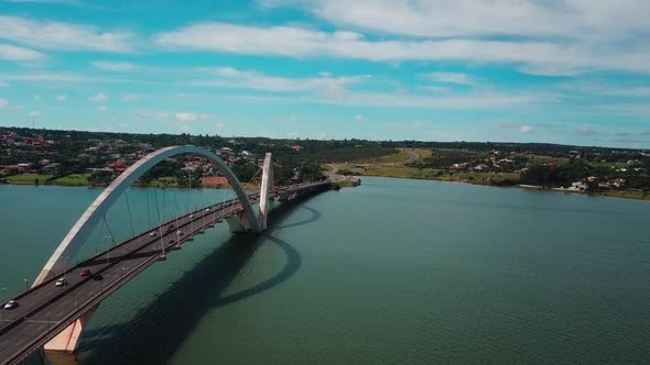 Beautiful aerial drone shot flying backwards next to the Juscelino Kubitschek Bridge in Brasilia alt