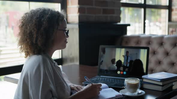 Distance Learning, Girl Working at the Computer in a Restaurant