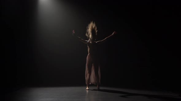 Motion of a Girl Practicing Contemp in Dark Studio. alt