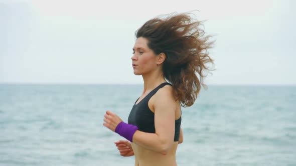 Beautiful Young Female Athlete Running Outdoors, Training for Sports Competition alt