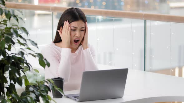 Confused Asian Woman Worker User Reading Bad Email on Laptop Feeling Depressed Shock Stress of alt