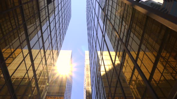 Modern skyscrapers in business district against blue sky alt