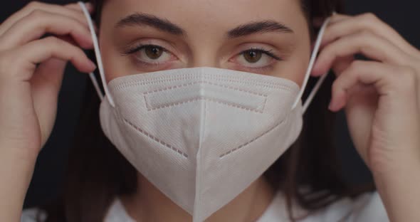 Beautiful Woman Put on Face Mask To Protect From Second Wave of Coronavirus Pandemic Outbreak alt
