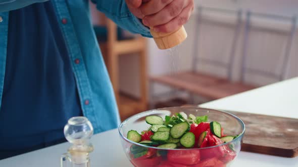 Pouring Salt Over Healthy Salad alt