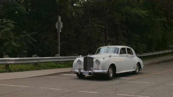 Old Classic Rolls Royce car on the road alt