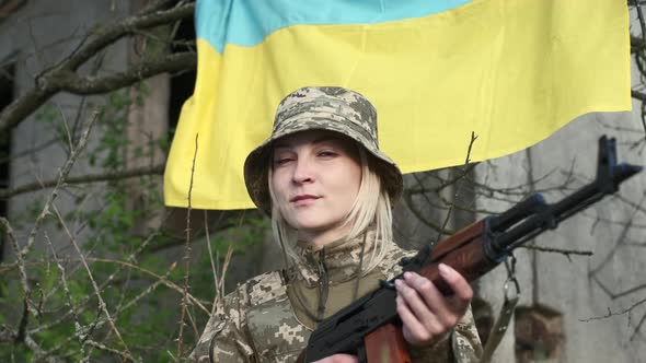 Portrait of Female Soldier in Camouflage Uniform Looking at the Camera