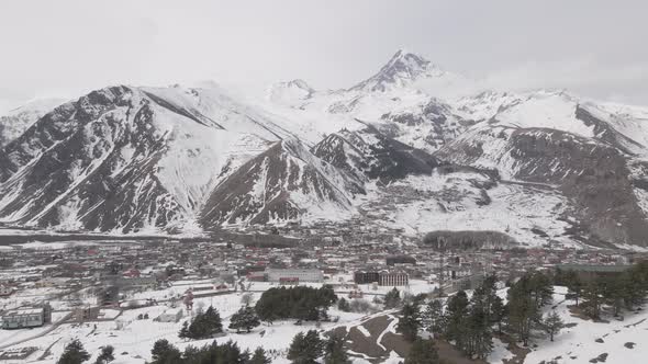 Aerial view of beautiful snowy mountains in Stepantsminda, Georgia alt