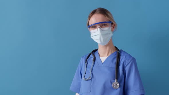 Nurse gesturing the a-okay sign while working