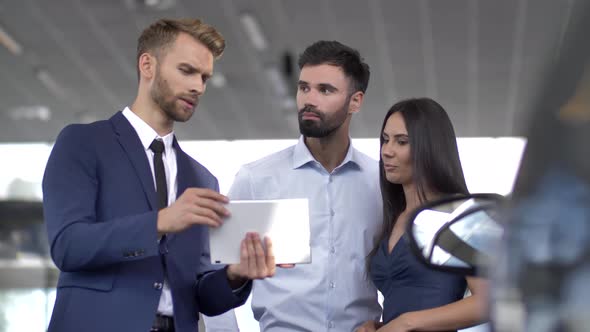 Car Buyers and Auto Dealer Meeting at Dealership alt