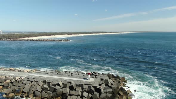Drone shot - flying away with a great view of the Gold Coast Seaway and South Stradbroke Island, Que alt