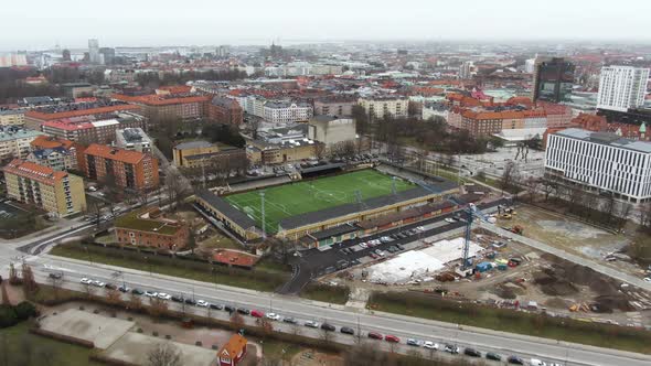 People playing on soccer field at Malmo city in Sweden. Aerial drone view alt