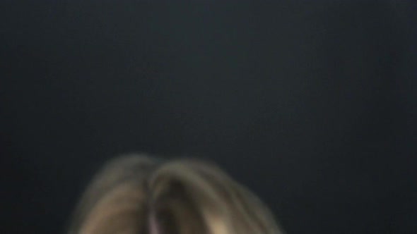 Slow motion shot of woman tossing hair