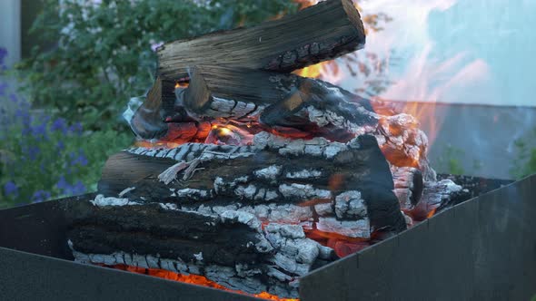 Make fire flames from firewoods for grill. Flaming backyard charcoal. Bonfire for grill or BBQ alt