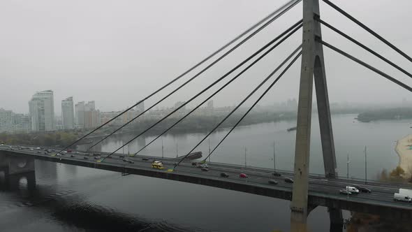 Huge concrete grey bridge with steel cables is combined two sides of metropolis in industrial smog alt