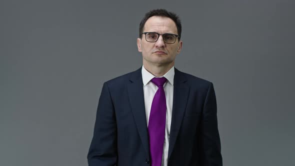 Overworked Tired Office Worker Takes Off Glasses, Holds Hand on Bridge of Nose alt