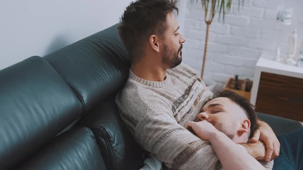 Happy Newlywed Homosexual Male Couple Spending Quality Time Together Cuddling and Relaxing on the alt