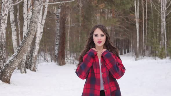 Charming Female with Long Hair Walking in Snowy Forest