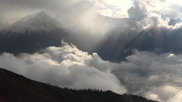 Snowy Mountains and Valleys Above the Clouds alt