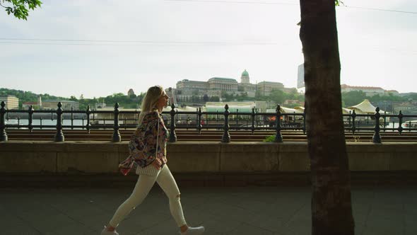 Woman walking along the riverside alt